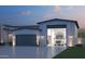 A stunning home exterior featuring a large RV garage and landscaping at 7575 W Gelding Dr, Peoria, AZ 85381
