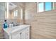 Bathroom with a vanity and large mirror, showcasing modern tile and fixtures at 945 E Missouri Ave, Phoenix, AZ 85014