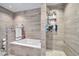 Updated bathroom with a bathtub and shower, featuring sleek tile and fixtures at 945 E Missouri Ave, Phoenix, AZ 85014