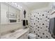 Clean bathroom with updated vanity and a Halloween-themed shower curtain at 5883 E Thomas Rd, Scottsdale, AZ 85251