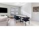 Bright dining area with a modern table and four black velvet chairs at 12379 W Chase Ln, Avondale, AZ 85323