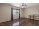 Well-lit bedroom with large window and dark wood floors at 11451 N 103Rd Ave, Sun City, AZ 85351