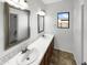 Bathroom with double sinks and updated vanity at 7916 S 52Nd Ave, Laveen, AZ 85339