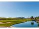 Golf course with pond and mountain views at 26404 W Zachary Dr, Buckeye, AZ 85396