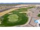 Aerial view of a beautiful golf course with sand traps and lush greens at 26404 W Zachary Dr, Buckeye, AZ 85396