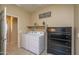 Laundry room with washer, dryer, and shelving at 26404 W Zachary Dr, Buckeye, AZ 85396
