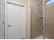 Clean bathroom with a shower and a white door at 26404 W Zachary Dr, Buckeye, AZ 85396