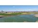 Scenic view of the golf course with a pond and mountain backdrop at 26404 W Zachary Dr, Buckeye, AZ 85396