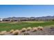 Homes overlook a putting green and a scenic mountain backdrop at 26404 W Zachary Dr, Buckeye, AZ 85396