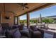 Relaxing covered patio with seating area and backyard access at 26404 W Zachary Dr, Buckeye, AZ 85396