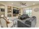 Living room with built-in shelving and a large TV at 26404 W Zachary Dr, Buckeye, AZ 85396
