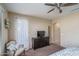 Bright bedroom with a dresser, chair, and large window at 26404 W Zachary Dr, Buckeye, AZ 85396