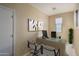 Home office with a desk, two chairs, and artwork at 26404 W Zachary Dr, Buckeye, AZ 85396