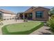 Wonderful backyard with putting green, patio furniture, and covered patio at 26404 W Zachary Dr, Buckeye, AZ 85396
