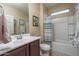 Bathroom with tub, shower, and striped curtain at 26404 W Zachary Dr, Buckeye, AZ 85396