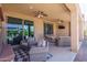 Extended covered patio with multiple seating areas and fireplace at 26404 W Zachary Dr, Buckeye, AZ 85396