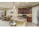 Kitchen with curved island, dark cabinets, and granite countertops at 26404 W Zachary Dr, Buckeye, AZ 85396