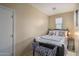 Small bedroom with a bed and bench at 26404 W Zachary Dr, Buckeye, AZ 85396
