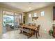 Dining area with wooden table and bench, and view of backyard at 26404 W Zachary Dr, Buckeye, AZ 85396