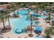 Large resort-style pool with palm trees and shade umbrellas at 26404 W Zachary Dr, Buckeye, AZ 85396