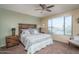 Bedroom with a rustic wooden bed frame and light teal bedding at 26404 W Zachary Dr, Buckeye, AZ 85396