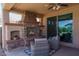 Relaxing patio featuring a stone fireplace and comfortable seating at 26404 W Zachary Dr, Buckeye, AZ 85396