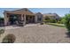 Spacious backyard with patio, putting green, and covered seating area at 26404 W Zachary Dr, Buckeye, AZ 85396