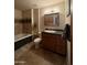 Bathroom with a jetted tub, granite vanity, and tiled floors at 3614 W Krall St, Phoenix, AZ 85019