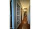 Long hallway with built-in shelving and terracotta tile floors at 3614 W Krall St, Phoenix, AZ 85019