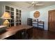 Home office with built-in shelving, wood desk, and hardwood floors at 3614 W Krall St, Phoenix, AZ 85019