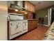 Kitchen with vintage stove and wood cabinets at 3614 W Krall St, Phoenix, AZ 85019