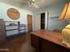 Bright office featuring a wood desk, built-in shelves, and hardwood floors at 3614 W Krall St, Phoenix, AZ 85019