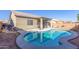 Kidney-shaped pool with surrounding patio and landscape at 13585 W Ironwood St, Surprise, AZ 85374