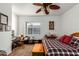 Bedroom with ceiling fan, dresser, and workspace at 13585 W Ironwood St, Surprise, AZ 85374