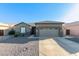 Single-story home with attached garage and desert landscaping at 13585 W Ironwood St, Surprise, AZ 85374