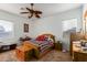 Bright bedroom with a ceiling fan and wood furniture at 13585 W Ironwood St, Surprise, AZ 85374