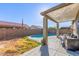 Relaxing kidney shaped pool with covered patio and grassy backyard at 13585 W Ironwood St, Surprise, AZ 85374