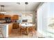 Kitchen with an island, wood cabinets, and sliding door to backyard at 13585 W Ironwood St, Surprise, AZ 85374