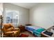 Small bedroom with a recliner and window at 13585 W Ironwood St, Surprise, AZ 85374