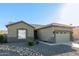 Single-story house with a two-car garage and desert landscaping at 13585 W Ironwood St, Surprise, AZ 85374