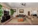Living room with couches, a coffee table, and a large TV at 13585 W Ironwood St, Surprise, AZ 85374