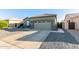 House exterior featuring a two-car garage and gravel landscaping at 13585 W Ironwood St, Surprise, AZ 85374