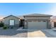 Single-story home with attached garage and desert landscaping at 13585 W Ironwood St, Surprise, AZ 85374