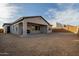 Back of house with covered patio and desert landscape at 27603 N 73Rd Dr, Peoria, AZ 85383