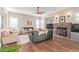 Living room with stone fireplace, hardwood floors, and ample natural light at 1452 E Prescott Pl, Chandler, AZ 85249