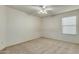 Well-lit bedroom featuring a window with blinds and ceiling fan at 11533 E Pratt Ave, Mesa, AZ 85212