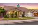 House exterior view at dusk, showing landscaping and street view at 11533 E Pratt Ave, Mesa, AZ 85212