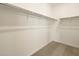 Large walk-in closet with double hanging rods and shelving at 17342 W Sanna St, Waddell, AZ 85355