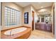 Luxurious bathroom with a large soaking tub and double vanity at 9588 E Preserve Way, Scottsdale, AZ 85262