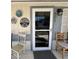 Front entry with storm door, house numbers, and decorative accents at 2400 E Baseline Ave # 301, Apache Junction, AZ 85119